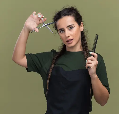 Hairstylist with braids holding scissors and comb