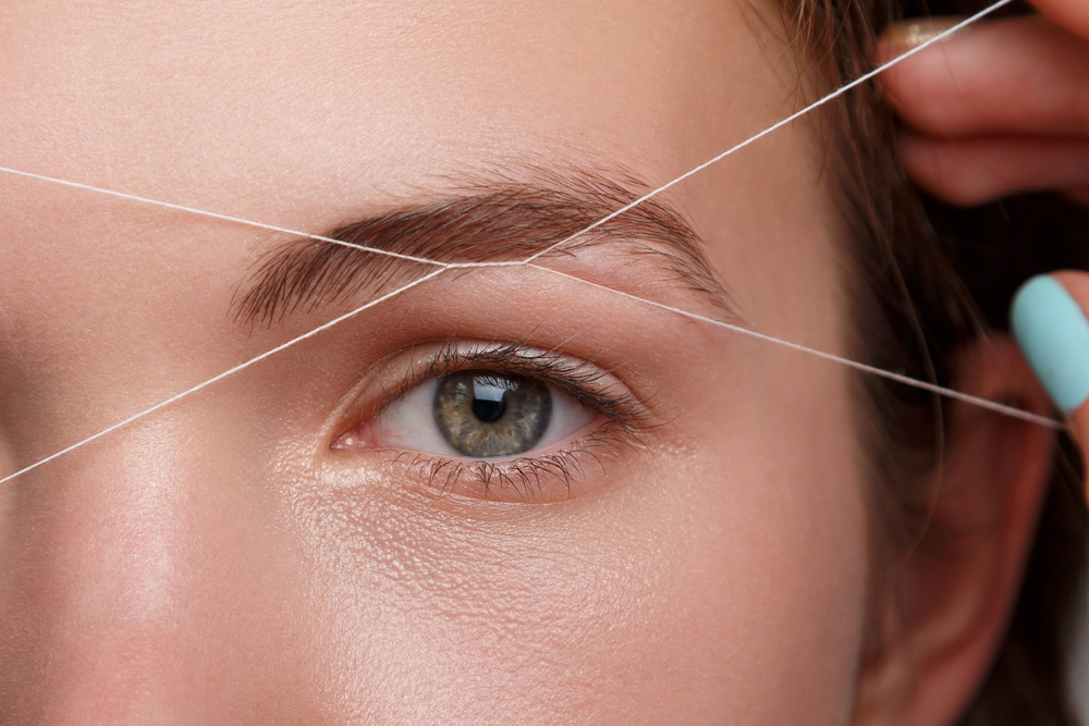 threading eyebrow technique shown on one eyebrow